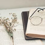 black framed eyeglasses on book page